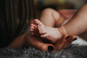 Mother holding baby's feets