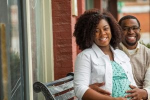 Smiling Afro-American couple expecting a child